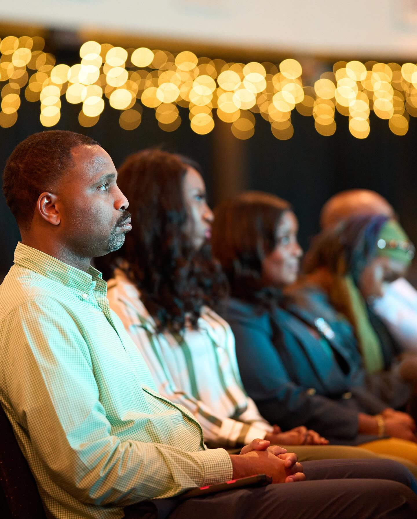 Audience watching a presentation at a Pulse Awards event, with atmospheric bokeh lighting
